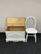 A pine blanket box together with a pair of painted kitchen chairs
