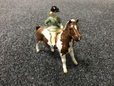 A Beswick figure - a girl on a pony, skew bald, model 1499,