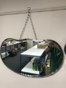 A frameless bevelled heart shaped mirror