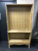 A set of blond oak open bookshelves