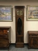 An early twentieth century oak regulator clock with glass panelled door CONDITION REPORT: