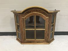 A walnut single door wall mounted display cabinet