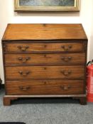An early nineteenth century mahogany bureau on bracket feet,