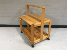 A pine two tier folding trolley