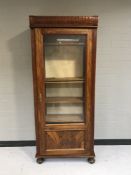 A late nineteenth century walnut glazed door bookcase