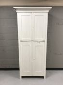 An early twentieth century painted pine double cupboard
