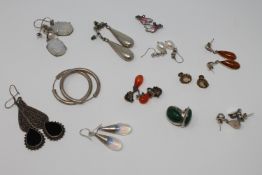 Twelve pairs of silver earrings (24)