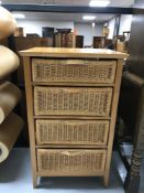 A pine four drawer chest with wicker drawers