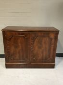 A mahogany double door cupboard