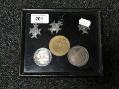A small display case containing five early twentieth century silver school medals together with one