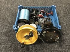 A basket of five fishing reels including fixed spool and multiplier, line,