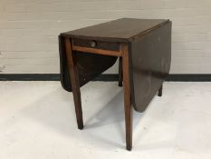An early twentieth century mahogany drop leaf table