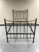 A painted metal and brass 4' bed frame