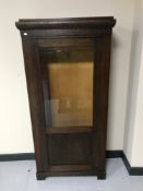 An early twentieth century oak glazed door bookcase