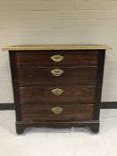 A twentieth century pine four drawer chest with brass handles