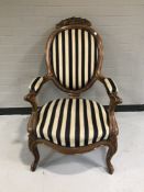 A late nineteenth century mahogany salon armchair upholstered in blue and white fabric