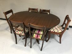 An inlaid mahogany circular pedestal dining table with leaf together with six chairs