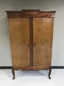 An early 20th century mahogany double door cabinet with inlaid doors