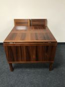A late 20th century Danish rosewood flap sided dining table and two extension leads