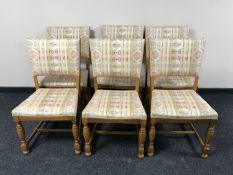 Six oak dining chairs upholstered in multi colour fabric
