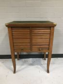 A mid twentieth century teak shutter door cabinet