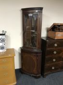 An inlaid mahogany corner display cabinet
