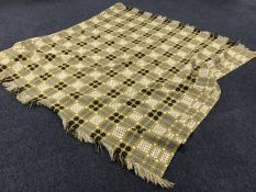 A hand stitched fringed bed throw