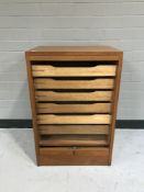 A mid twentieth century teak shutter door office cupboard