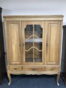 A twentieth century oak sideboard with glazed panel door