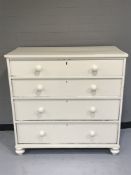 An antique painted pine four drawer chest