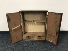 A mid 20th century double door tool cupboard