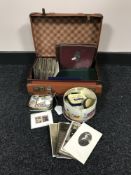 A leather case containing early twentieth century black and white post cards,