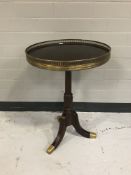 A mahogany wine table with a brass gallery