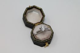 A silver solitaire cz dress ring.