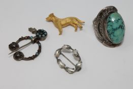 A small collection of silver jewellery including a silver-gilt dog brooch
