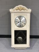 A painted wall clock with silvered dial