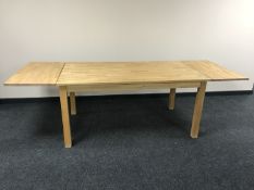 An oak dining table with two extension leaves
