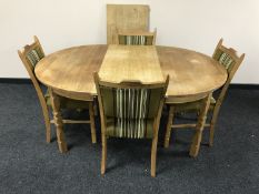 A blond oak circular dining table,