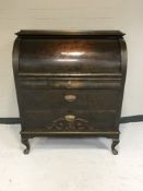 An early 20th century barrel fronted bureau