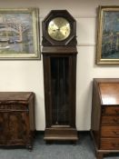 An early twentieth century oak regulator clock with glass panelled door and brass dial