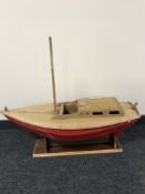 A hand built wooden model of a single mast boat on stand signed Grasole