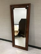 A late nineteenth century mahogany and walnut bevelled wall mirror