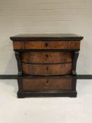 A nineteenth century mahogany four drawer chest with carved pillar supports
