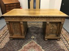 A nineteenth century carved oak pedestal desk,