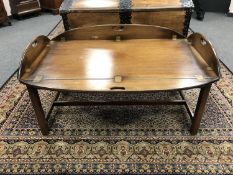 A traditional style mahogany butler's table with lift-up sides,