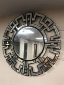A sectional circular contemporary mirror,