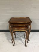 A nest of three mahogany tables on cabriole legs