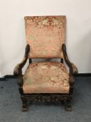 An eighteenth century style carved oak armchair, width 70 cm.