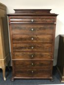 A nineteenth century mahogany seven drawer chest on paw feet