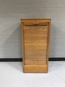 A mid twentieth century teak shutter door office cupboard